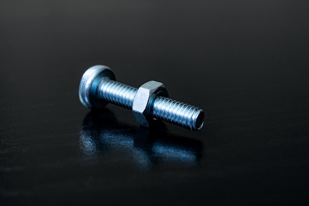 Bolt and nut on a wooden background