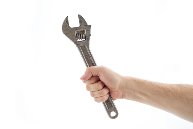 Photo bolt wrench adjustable cap wrench in the hand of a worker builder isolated on a white background