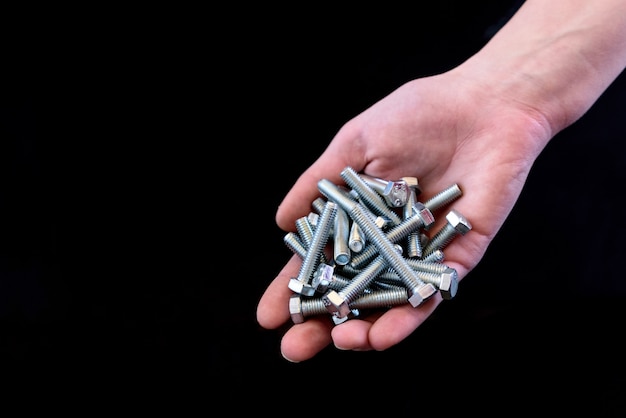 Bolts on hand isolated on black background