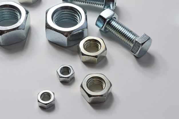 Bolts and screw-nut of different sizes. Concept. White background.