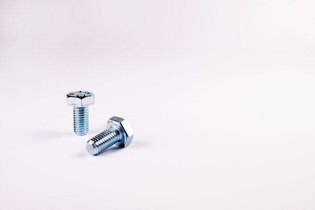 Bolts on white background, free space