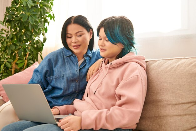 bonding moment mother and daughter engrossed in laptop