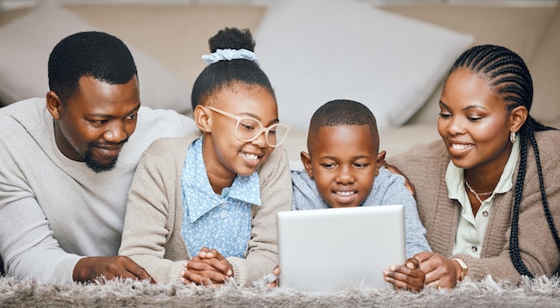 Bonding over series Shot of a young family using a digital tablet at home