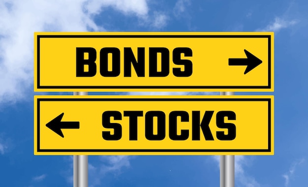 Bonds or stocks road sign on cloudy sky background