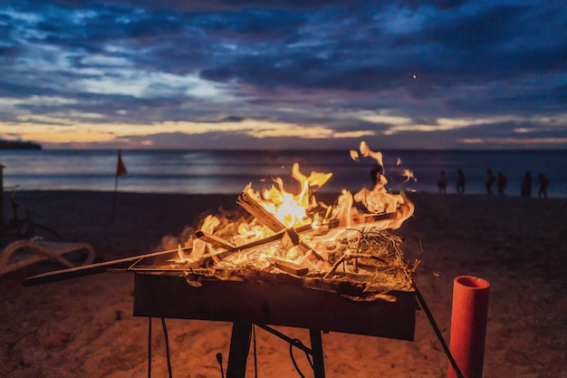 Bonfire on the background of the sea and sunset