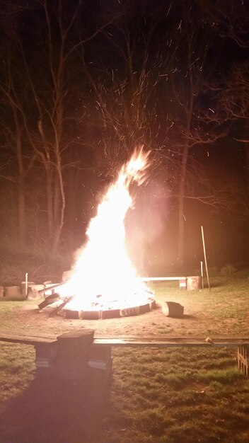 Bonfire in backyard against sky