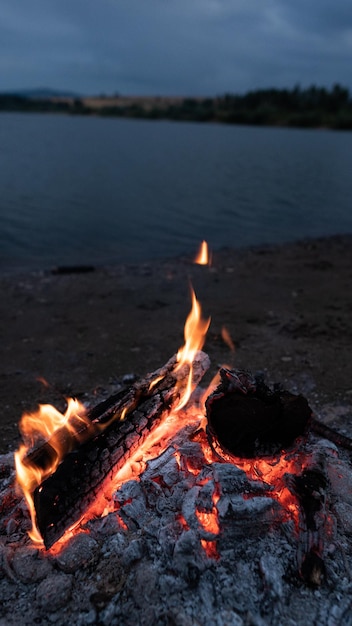 Bonfire on the shore of the lake Aesthetics of nature mobile phone wallpaper