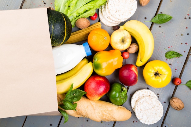 Boodschappen doen . Verschillende voedseldocument zak op houten. Plat leggen.