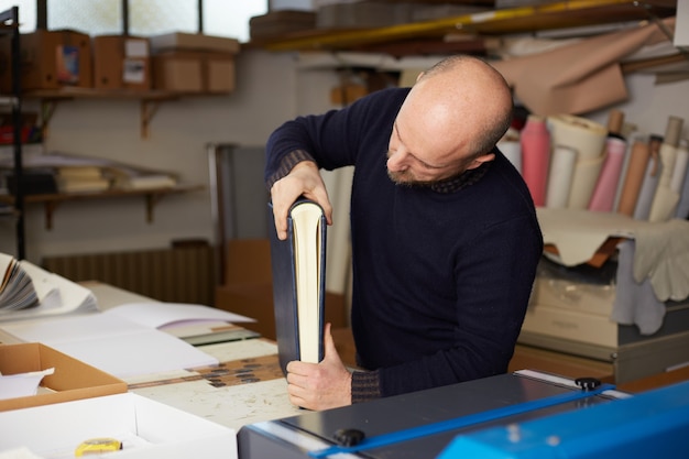 Book binder working in a warehouse