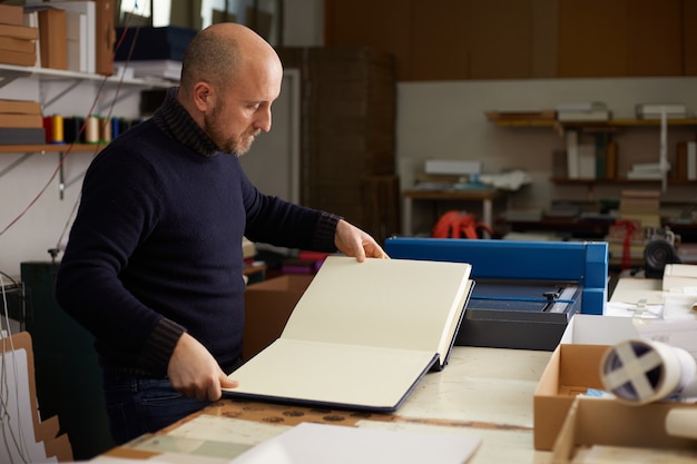 Book binder working in a warehouse