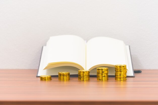 Book and coin pile ideas Business growth on the desk