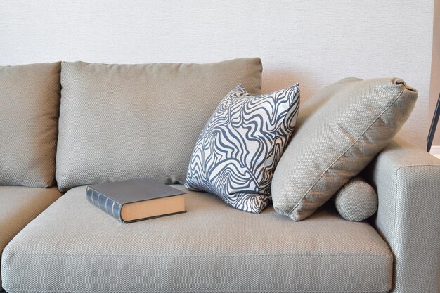 Photo book and cushions on sofa at home