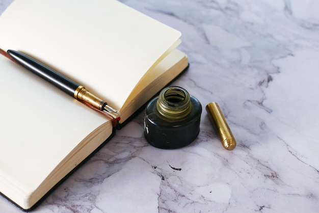 Book fountain pen and ink on table