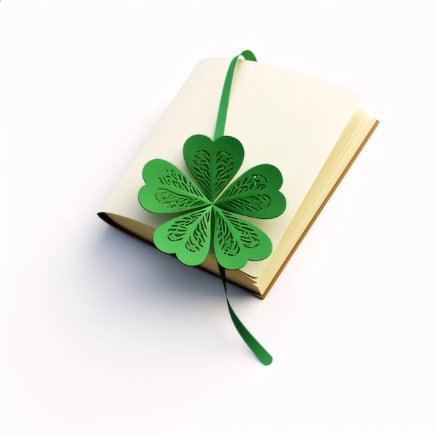 Book and froth of green fiveleaf clover white background Green fourleaf clover symbol of St Patricks Day