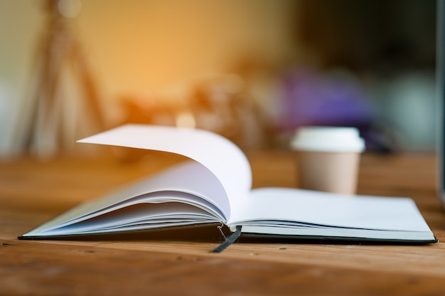 The book is placed on a business desk. The concept of reading with copy space.