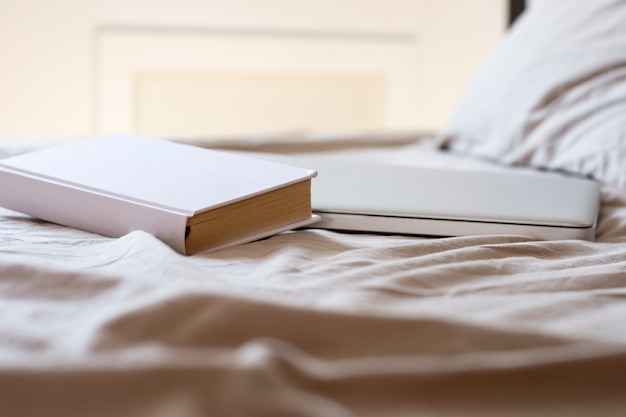 Photo book and laptop in bed