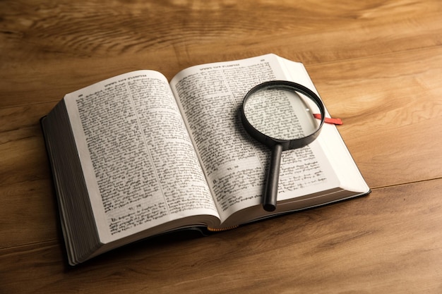 Book and magnifying glass