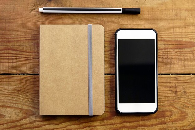 Photo book and mobile phone on table