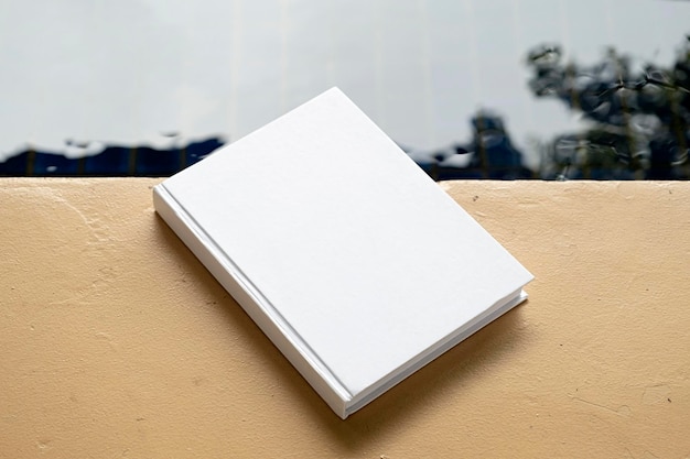 book mockup on wooden floor near pool or pond