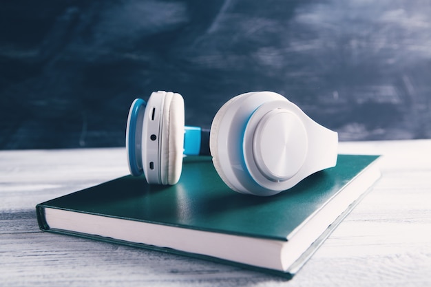 Book and modern headphones