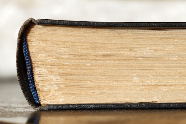 Book old, binding rib captal spine, close-up macro view