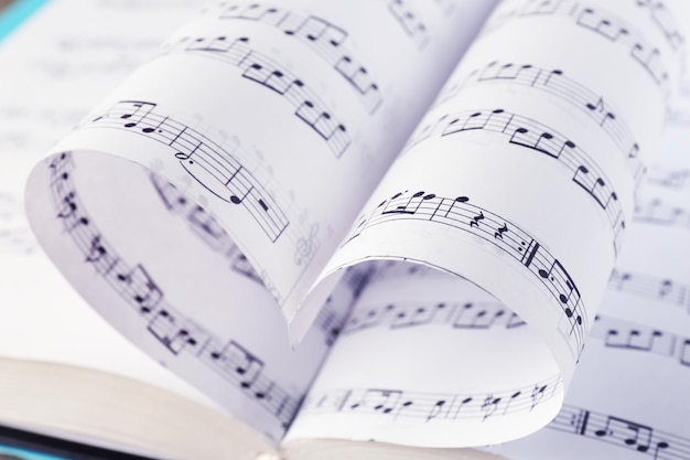 Photo book pages curved into heart shape close up