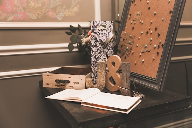 A book on a table with a box of flowers on it