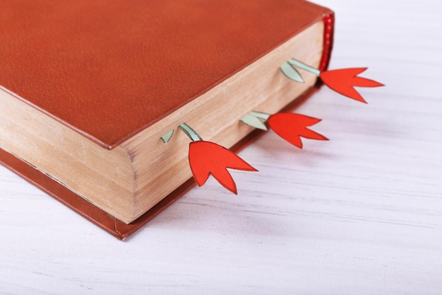 Книга с закладками на деревянном фоне