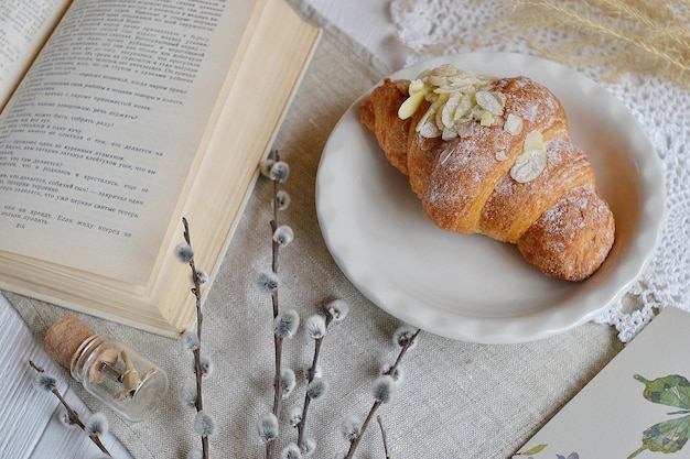 Photo a book with a croissant on it next to a book that says 