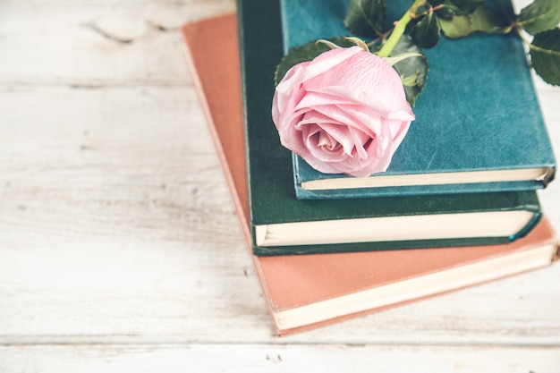 Book with roses on the wooden table