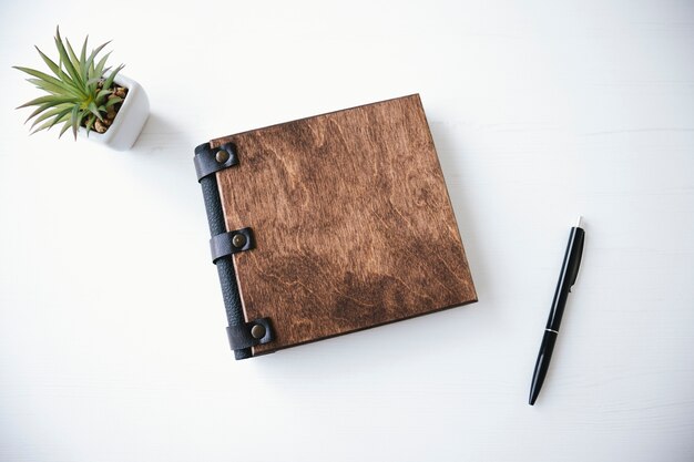 Book with wooden cover and pen