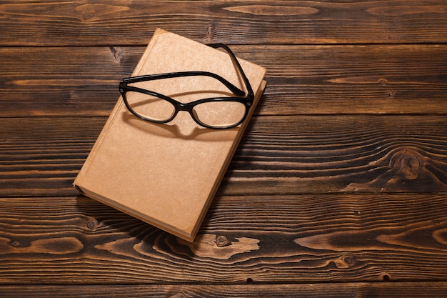 Book on wooden table. top view