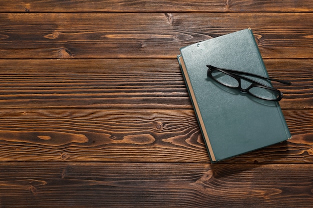 Book on wooden table. top view