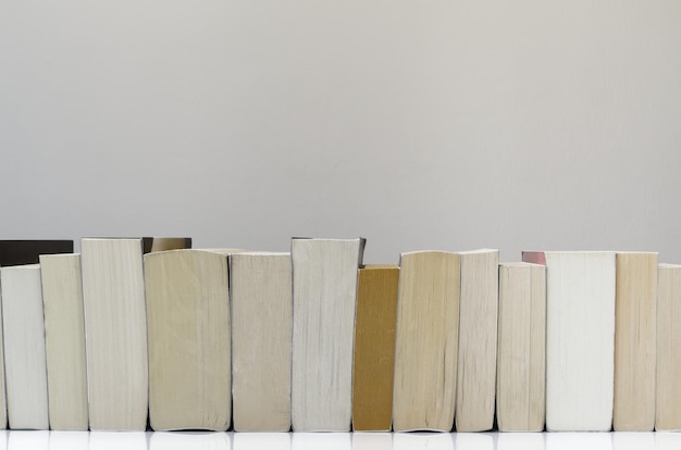 Books arranged on table against white background