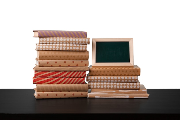 Books on black table against white background