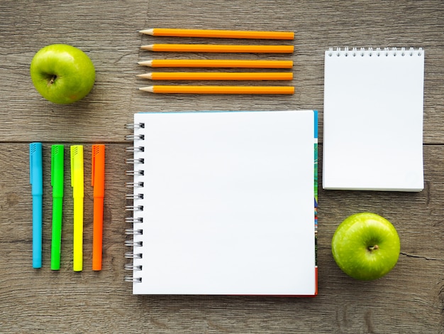 Books and blackboard on wooden background