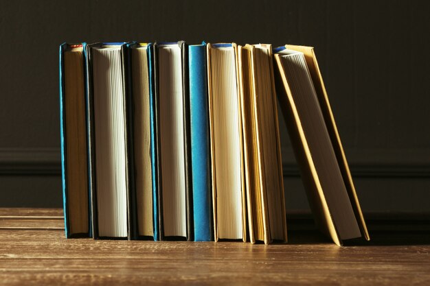 Books close up on old wooden table