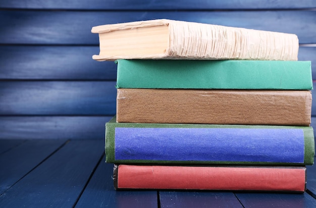 Books on dark blue wooden background