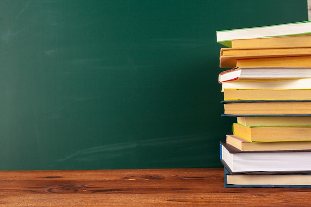 Books on Desk, Chalkboard Background