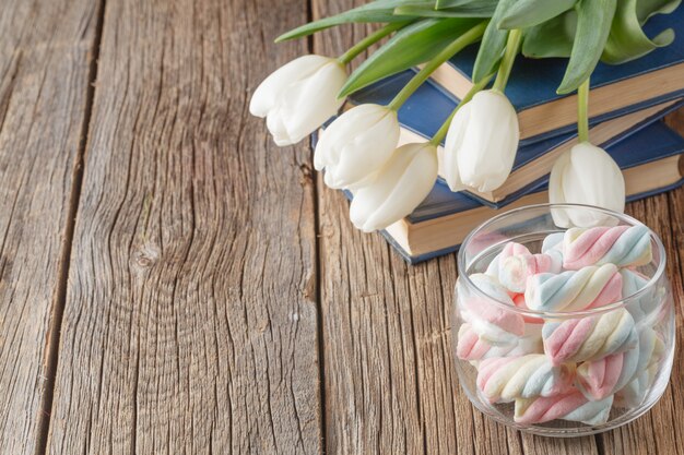 Books and flowers on wood table