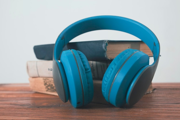 Books and headphones on a wooden table