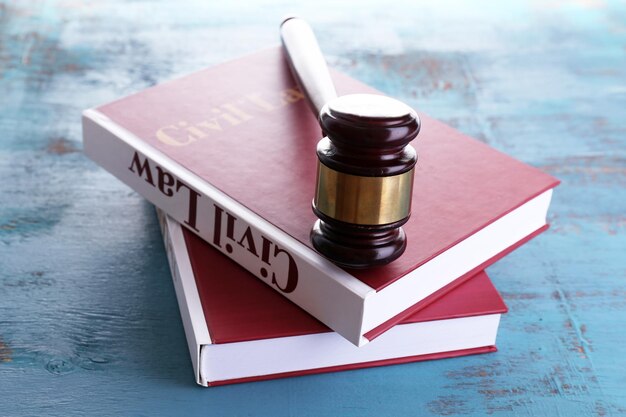 Photo books of law and hammer on table closeup