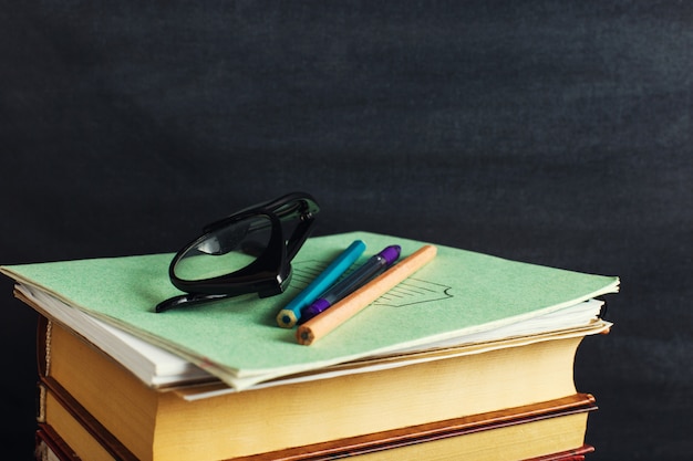 Books lie on the background of the chalk board