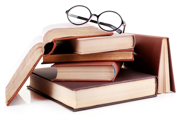 Books in a mess and glasses isolated on white