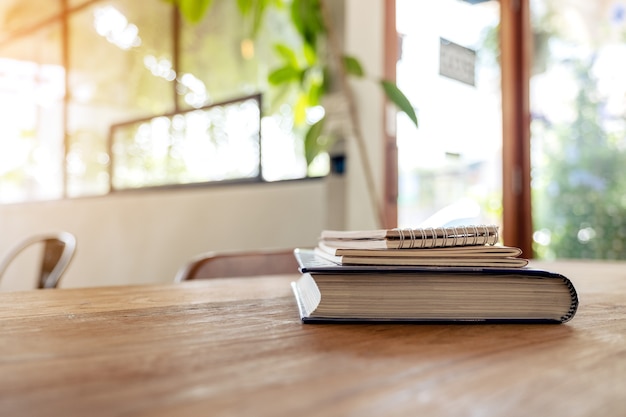 Books and notebooks on wooden table