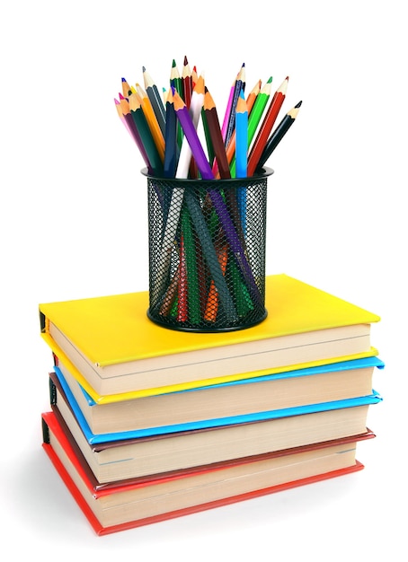 Books and pencils. On a white table.