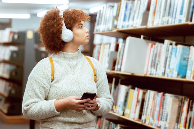 Photo books phone or student in a library to search for knowledge or university education for future growth scholarship radio music or school girl in headphones studying or learning college information