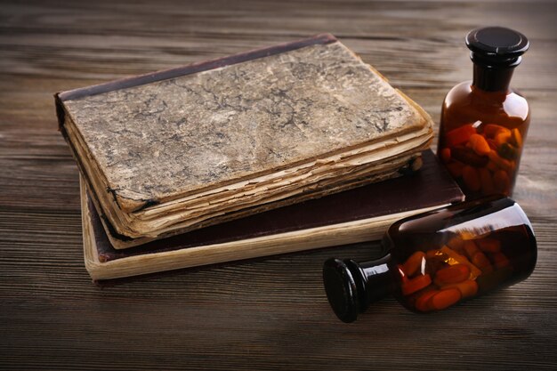 Photo books and pills on wooden table closeup