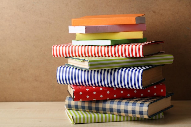 Books on shelf closeup on wooden background