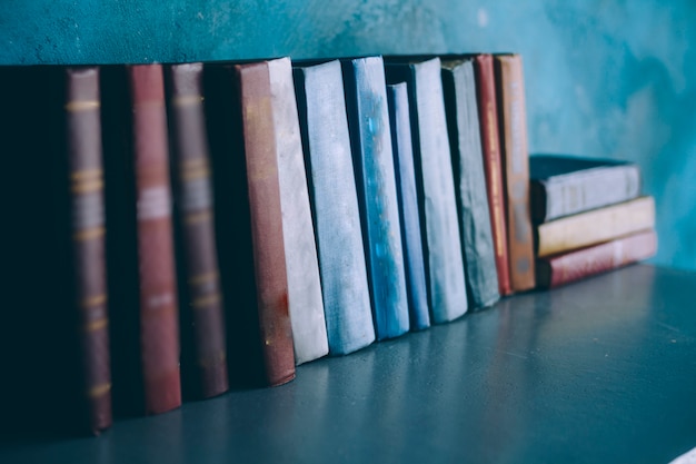 Photo books stand on a shelf